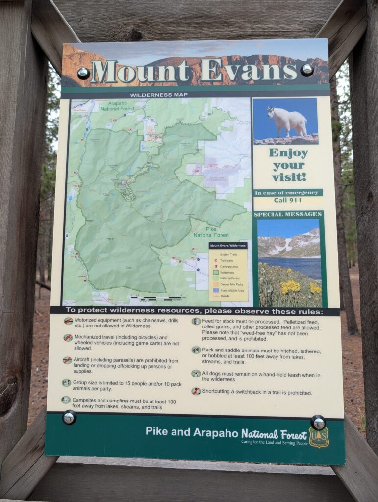 A Mount Evans Wilderness information board with a map and wilderness rules.